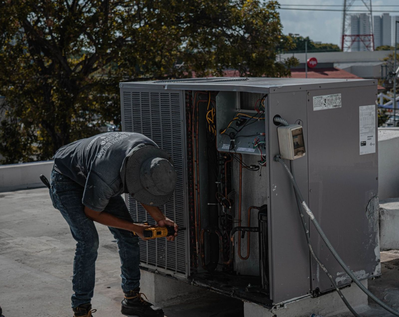 A technician working on an air conditioning unit
